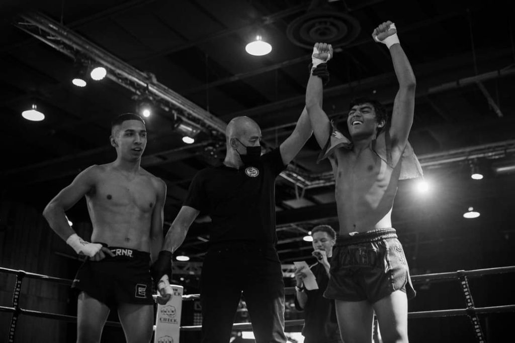 81's Fight Club fighter celebrating a win in the ring.
